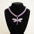 Purple Dragonfly Necklace on Off-White Background